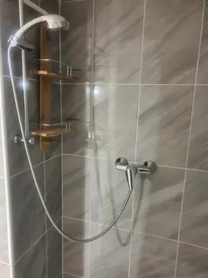 a shower with a hose attached to a wall at Saint Dizier in Cannes