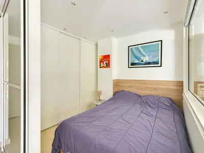 a bedroom with a purple bed in a room at Apartment Villa Schneider by Interhome in Cannes