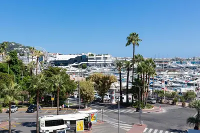 a city with a bus parked in a parking lot at Maracuja YourHostHelper in Cannes