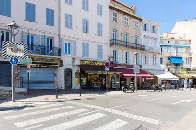 a city street with buildings and a crosswalk at Maracuja YourHostHelper in Cannes