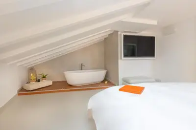 a bathroom with a sink and a bath tub at Hôtel Traverse Des Artistes in Cannes