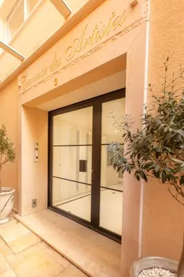 a store front with a large glass door at Hôtel Traverse Des Artistes in Cannes