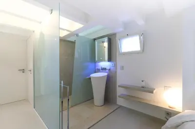 a bathroom with a glass shower and a sink at Hôtel Traverse Des Artistes in Cannes