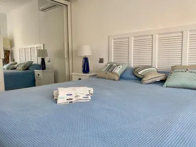 a bedroom with a blue bed with towels on it at Arthur Properties Rue d'Antibes in Cannes
