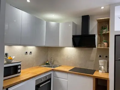a kitchen with white cabinets and a sink at Arthur Properties Rue d'Antibes in Cannes