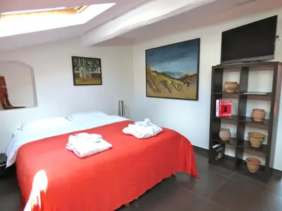 a bedroom with a red bed with towels on it at Arthur Properties Rue d'Antibes in Cannes