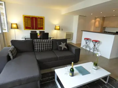 a living room with a couch and a table at Arthur Properties Rue d'Antibes in Cannes