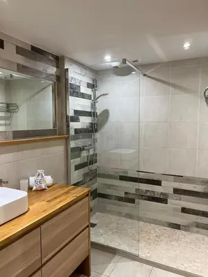 a bathroom with a glass shower and a sink at Arthur Properties Rue d'Antibes in Cannes