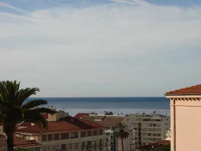 a view of the ocean from the roofs of buildings at ACCI Cannes Les Yuccas in Cannes