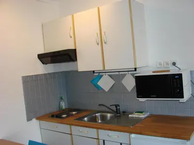 a kitchen with a sink and a microwave at ACCI Cannes Les Yuccas in Cannes