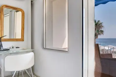 a room with a desk and a door with a view of the ocean at IMMOGROOM - 3 Sea view Panoramic terrace - 1 min beach - CONGRESSBEACH in Cannes