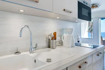 a kitchen with a sink and a counter top at IMMOGROOM - 3 Sea view Panoramic terrace - 1 min beach - CONGRESSBEACH in Cannes