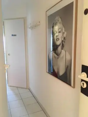 a picture of a woman on a wall in a bathroom at Appartement Belle Azur in Cannes