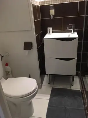a bathroom with a white toilet and a sink at Appartement Belle Azur in Cannes