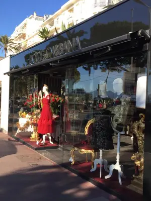 a store window with a red dress and other items at Appartement Belle Azur in Cannes