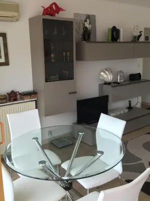 a glass table and chairs in a living room at Cannes: Agréable 2 pièces vue mer panoramique in Cannes