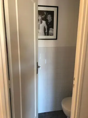a bathroom with a toilet and a picture on the wall at Cannes: Agréable 2 pièces vue mer panoramique in Cannes
