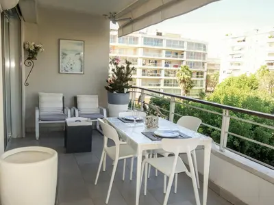 a balcony with a table and chairs on a balcony at Apartment Cristal Croisette-1 by Interhome in Cannes