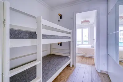 a white room with bunk beds in it at Le Marignan in Cannes
