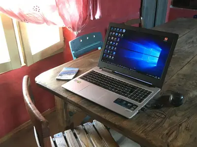 a laptop computer sitting on top of a wooden table at Appart Suquet Avec Terasse Vue Mer in Cannes