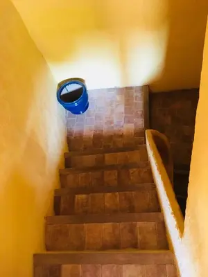 a spiral staircase with a blueigunigunigunigunigunigunigunigunigunigun at Appart Suquet Avec Terasse Vue Mer in Cannes