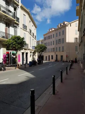 an empty street in a city with buildings at 45 Clemenceau by Welcome to Cannes in Cannes