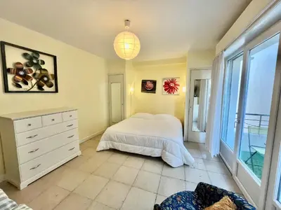 a bedroom with a bed and a dresser and a window at 45 Clemenceau by Welcome to Cannes in Cannes