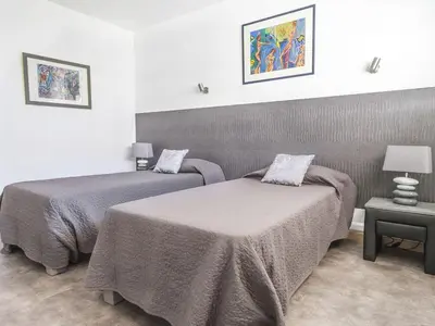 a bedroom with two beds and a table with a lamp at Lovely One bedroom Martinez Cannes in Cannes