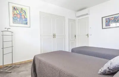 a white bedroom with two beds and a ladder at Lovely One bedroom Martinez Cannes in Cannes