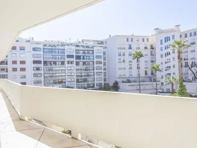 a view from the balcony of a building with palm trees at Lovely One bedroom Martinez Cannes in Cannes