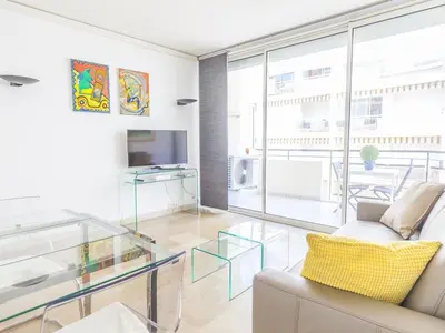 a living room with a glass table and a couch at Lovely One bedroom Martinez Cannes in Cannes