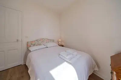 a bedroom with a white bed with towels on it at les néfliers in Cannes