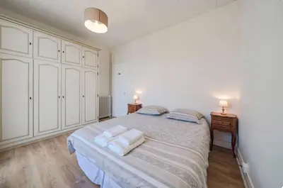 a bedroom with a large bed with towels on it at les néfliers in Cannes