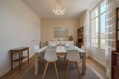 a dining room with a table and chairs at les néfliers in Cannes