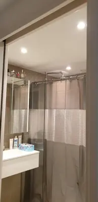 a bathroom with a shower curtain and a sink at Parc Impérial in Cannes