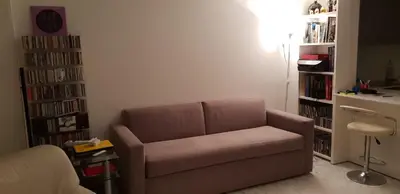 a living room with a couch and a book shelf at Parc Impérial in Cannes