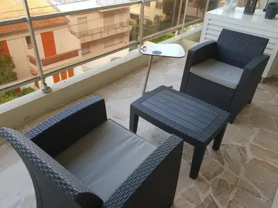 two chairs and a table on a balcony at Parc Impérial in Cannes