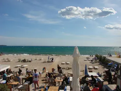 a group of people sitting on the beach at ACCI Cannes Croisette in Cannes