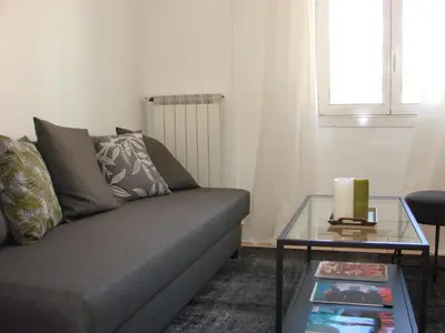 a living room with a couch and a glass table at ACCI Cannes Croisette in Cannes