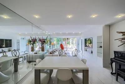 a dining room and living room with a piano at Appartement l'Age d'Or in Cannes