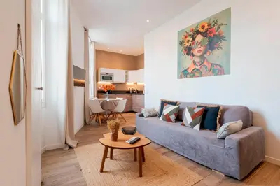 a living room with a couch and a table at Fabulous Central 1BR - Prime Location - Walk to Croisette & Palais - By Totolulu Cannes Blue Corner in Cannes