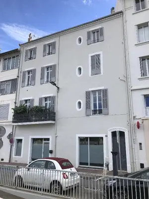 a white building with a car parked in front of it at Fabulous Central 1BR - Prime Location - Walk to Croisette & Palais - By Totolulu Cannes Blue Corner in Cannes