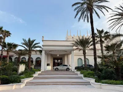 a car parked in front of a building with palm trees at Fabulous Central 1BR - Prime Location - Walk to Croisette & Palais - By Totolulu Cannes Blue Corner in Cannes