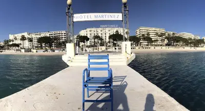a blue chair sitting on a dock near the water at Fabulous Central 1BR - Prime Location - Walk to Croisette & Palais - By Totolulu Cannes Blue Corner in Cannes