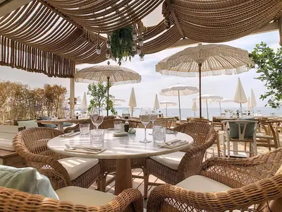 a restaurant with a table and chairs and umbrellas at Fabulous Central 1BR - Prime Location - Walk to Croisette & Palais - By Totolulu Cannes Blue Corner in Cannes