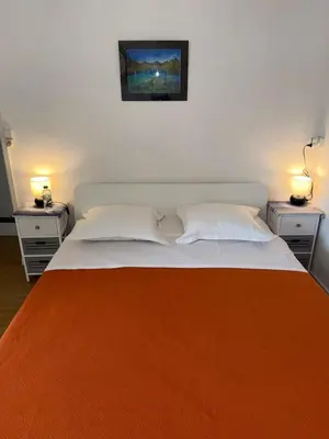 a bedroom with a large bed with two night stands at ACCI Cannes Riviera in Cannes