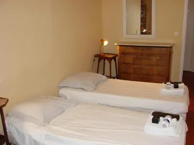 two beds in a hotel room with white sheets at ACCI Cannes Riviera in Cannes