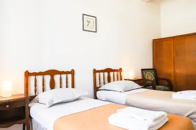 a room with two beds and a table and a desk at ACCI Cannes Riviera in Cannes