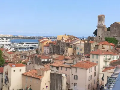 a view of a town with a clock tower at Lou Suquetan in Cannes