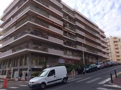 a white van parked in front of a large building at Lou Suquetan in Cannes